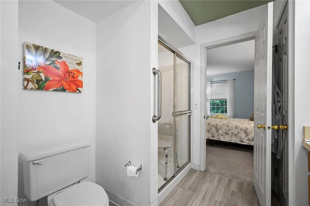 Bathroom featuring a stall shower, ensuite bathroom, and vanity