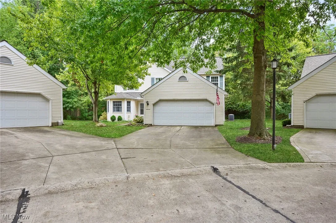 View of front facade with concrete driveway and a front yard
