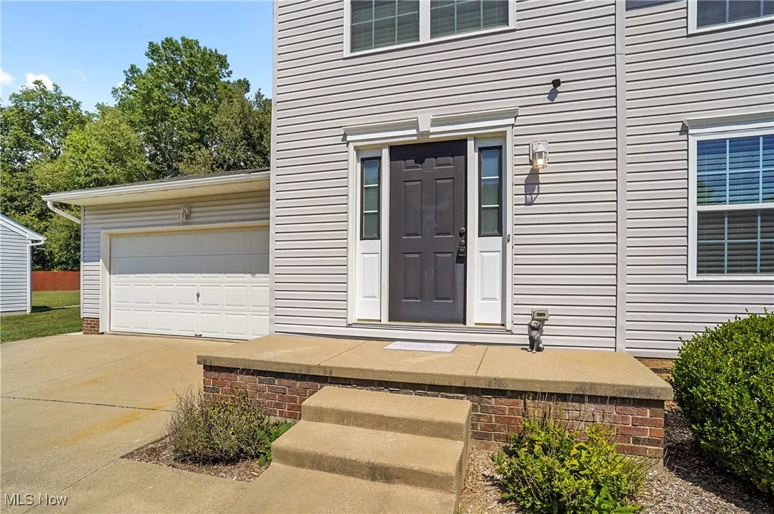 View of exterior entry featuring concrete driveway
