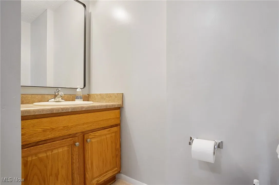 Half bath featuring vanity and a textured ceiling