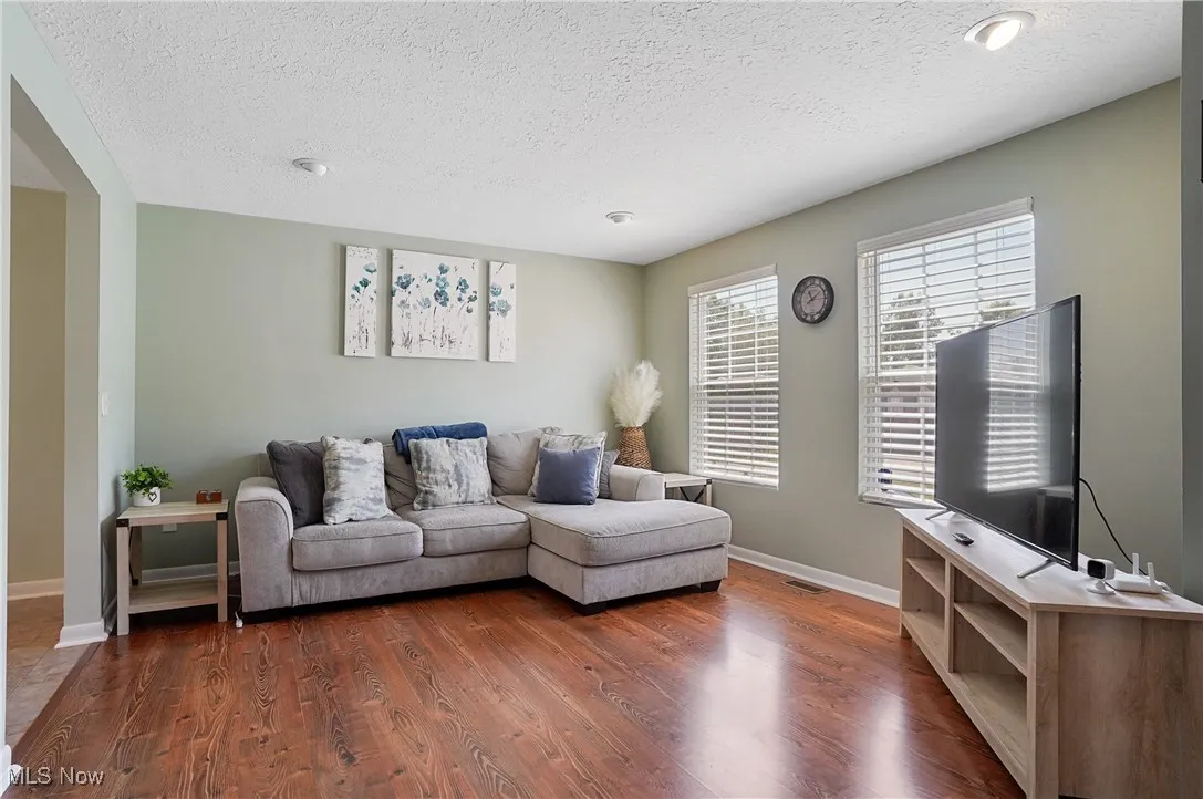 Living room featuring wood finished floors and a textured ceiling