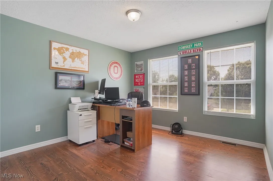 Office featuring a textured ceiling and wood finished floors