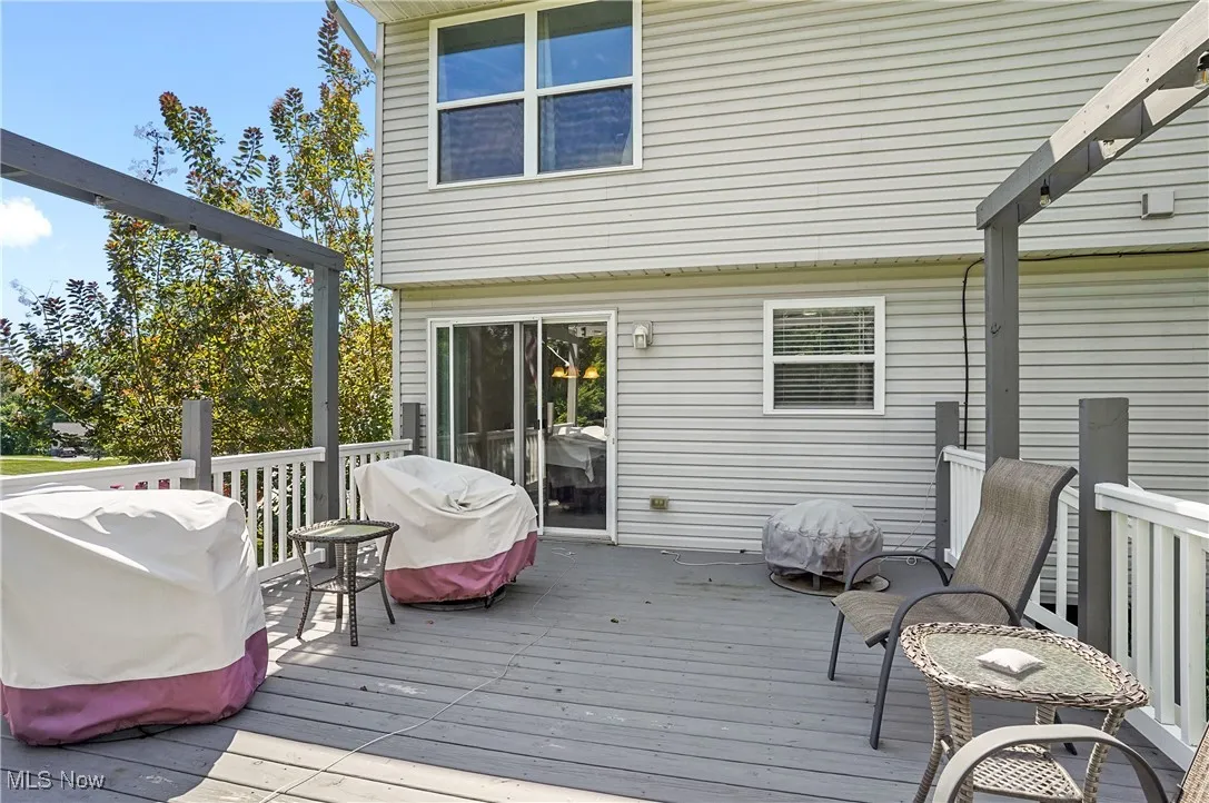 Wooden deck featuring area for grilling