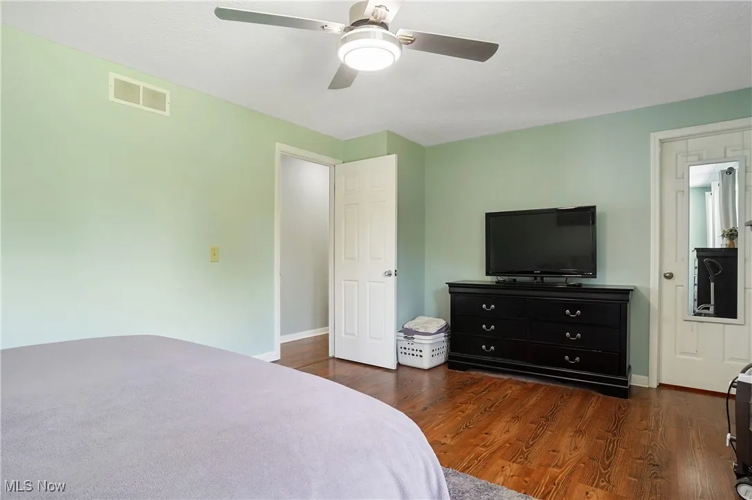 Bedroom featuring dark wood-style floors and a ceiling fan
