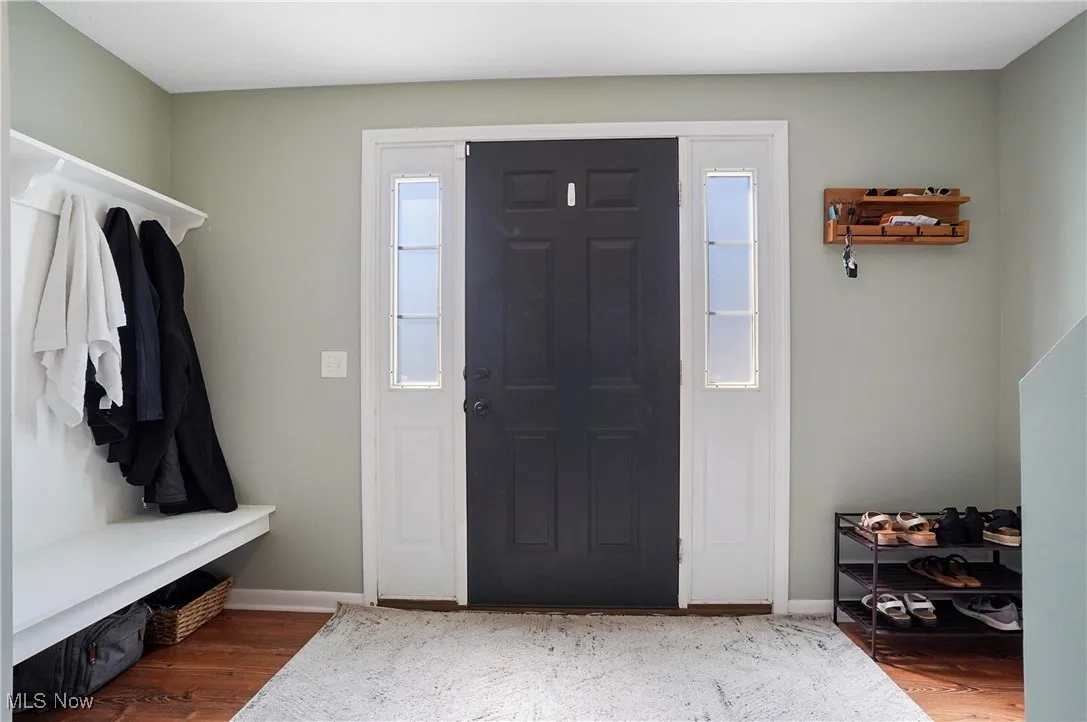 Entryway featuring wood finished floors and baseboards