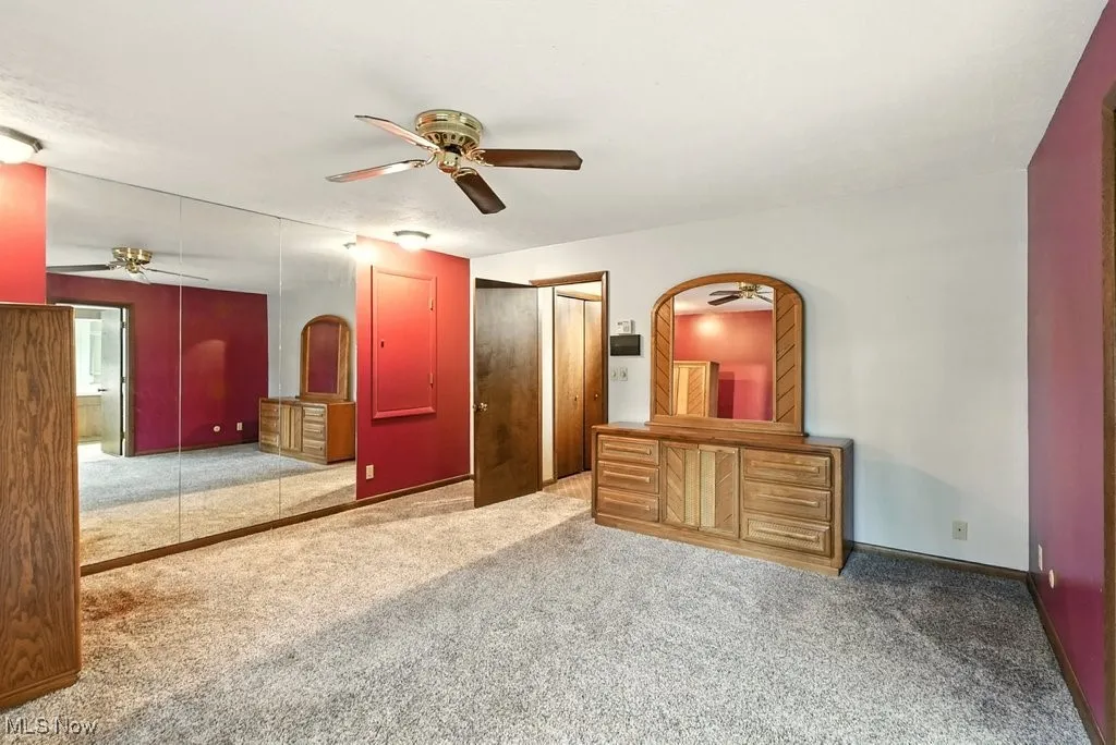 Unfurnished bedroom featuring carpet floors, a ceiling fan, and a closet