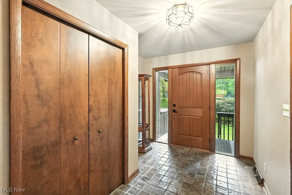 Entryway with baseboards and stone finish floors