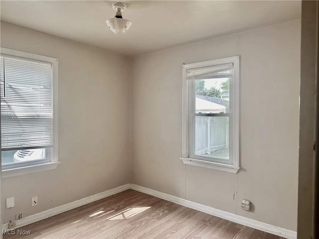 Bedroom featuring baseboards and light wood-type flooring