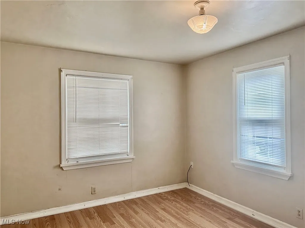 Bedroom with baseboards and light wood-type flooring