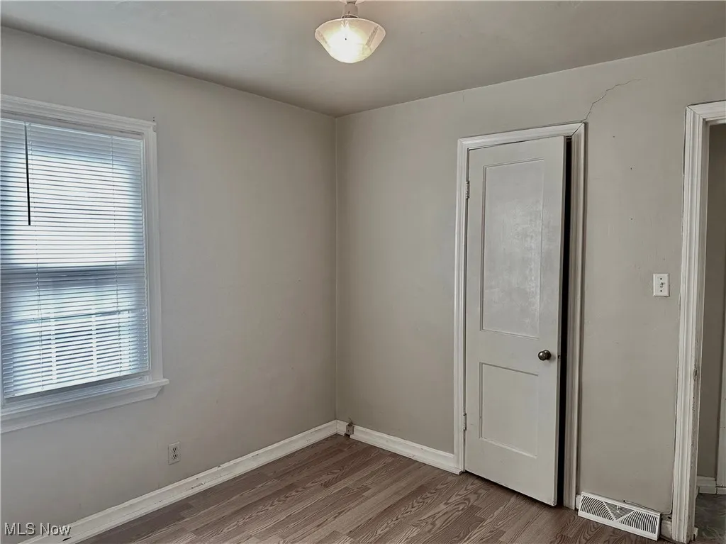 Bedroom with baseboards and wood finished floors