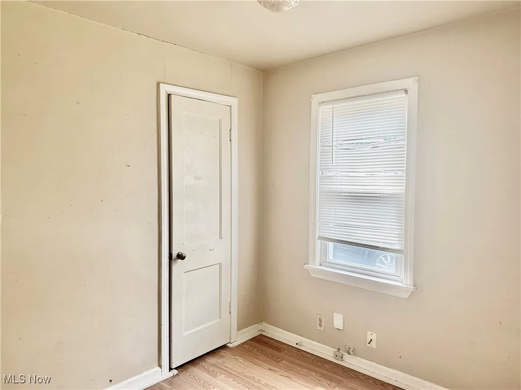 Bedroom with baseboards and light wood finished floors