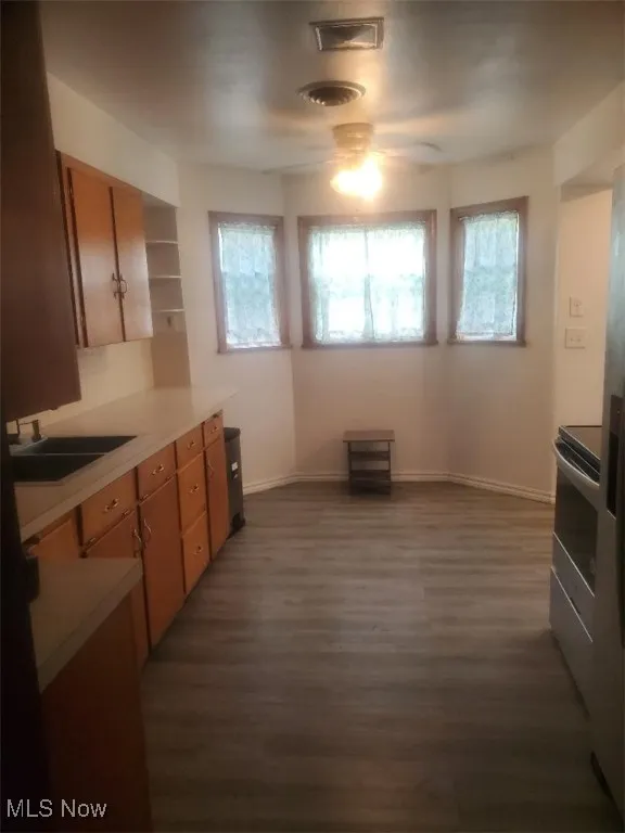 Kitchen with brown cabinetry, healthy amount of natural light, and light countertops