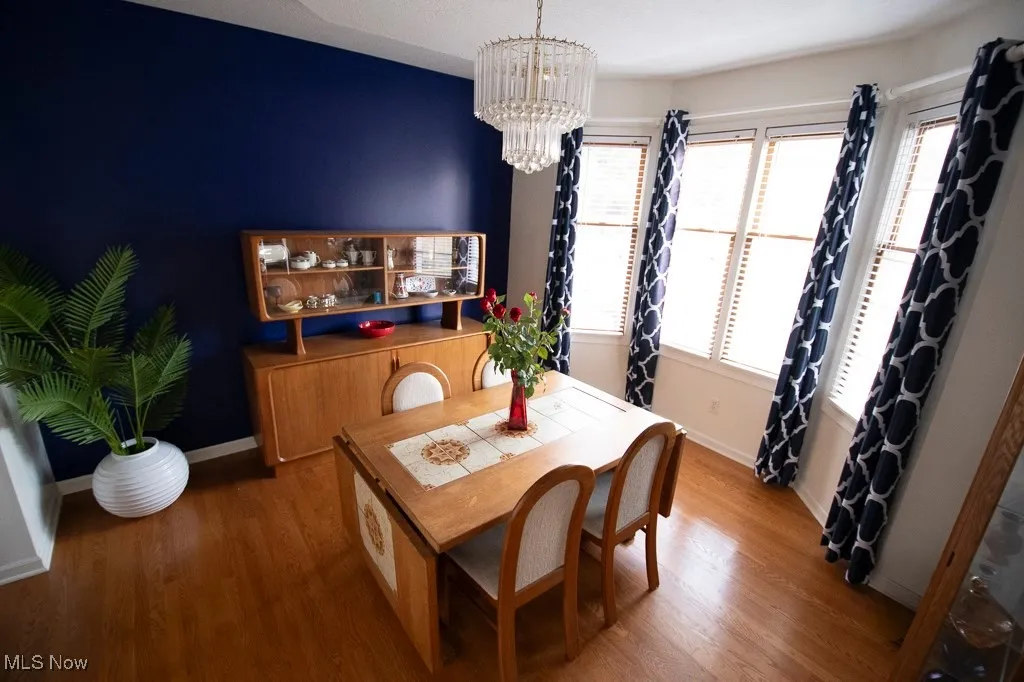 Dining room featuring wood finished floors and a chandelier