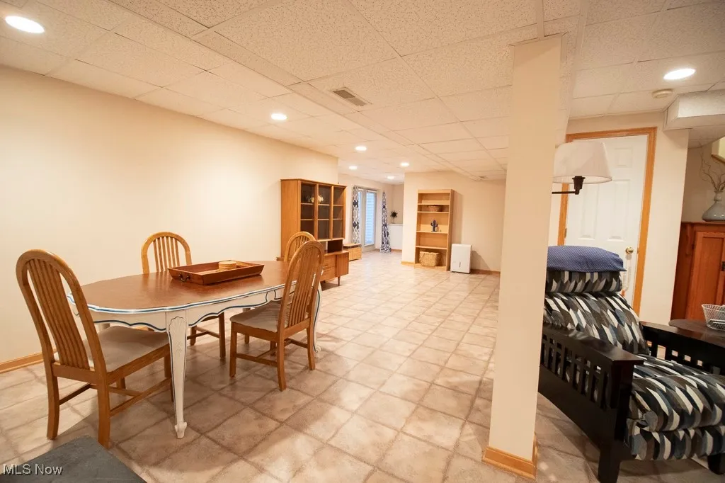 Dining area featuring a drop ceiling and recessed lighting