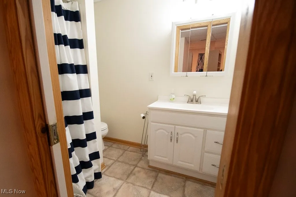Bathroom featuring vanity and a shower with shower curtain