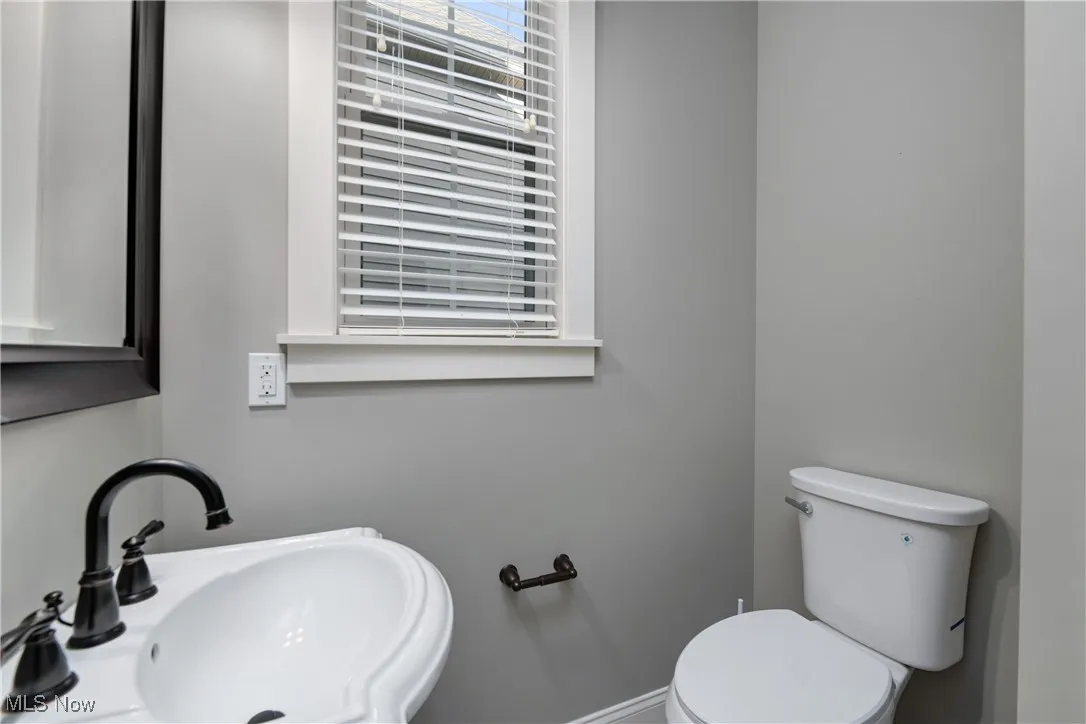 Half bathroom with a sink and toilet