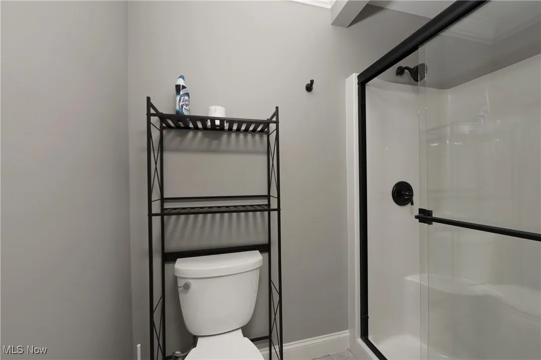 Full bath with a stall shower and toilet