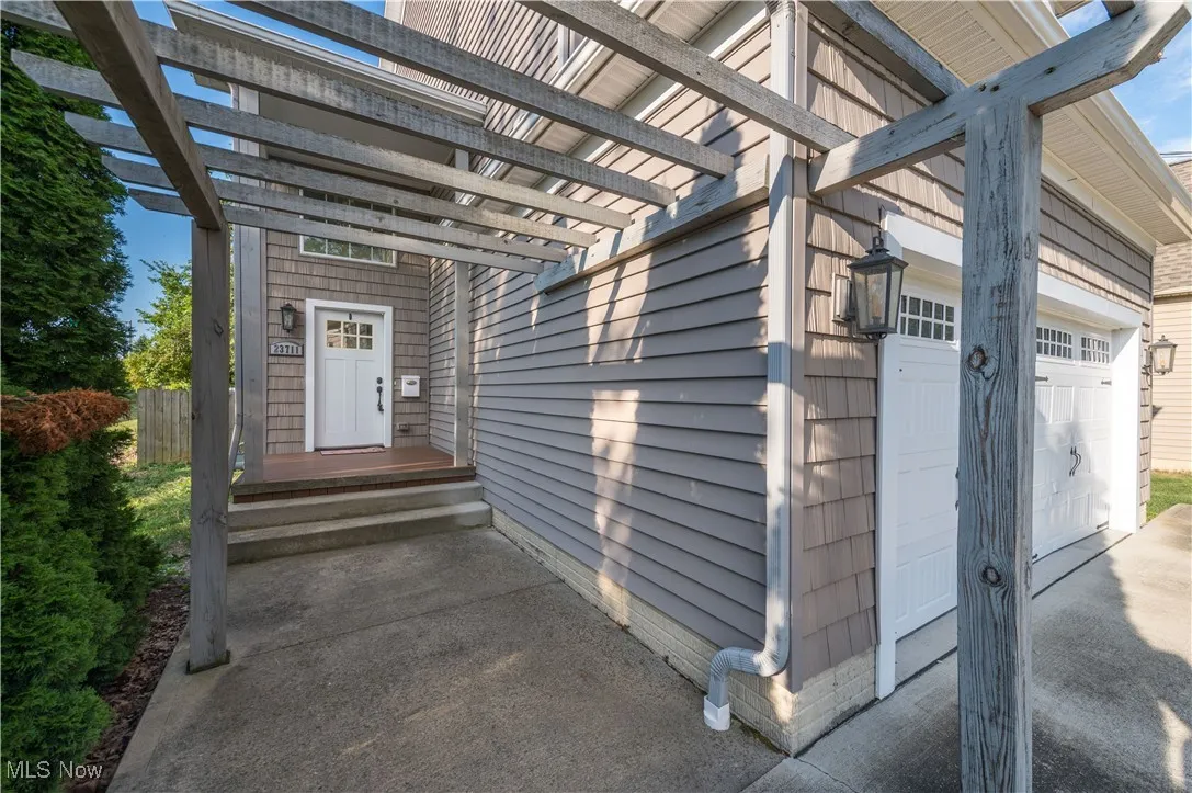 View of exterior entry with a garage