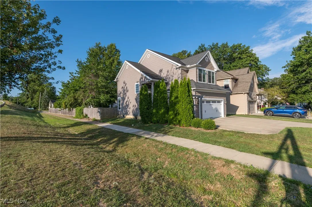 View of front of home with a garage and concrete driveway