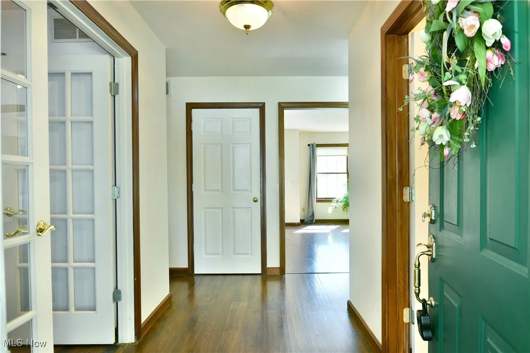 Foyer entrance with baseboards and dark wood finished floors