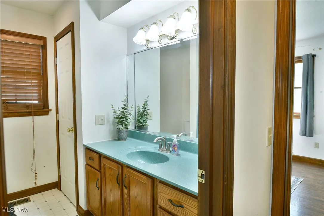 Bathroom with vanity and baseboards