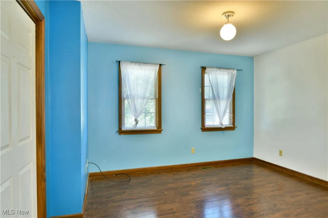 Unfurnished bedroom featuring wood finished floors and a closet