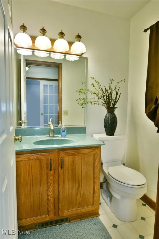 Bathroom with vanity and light tile patterned floors