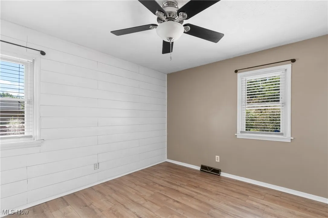 Spare room with light wood finished floors and baseboards