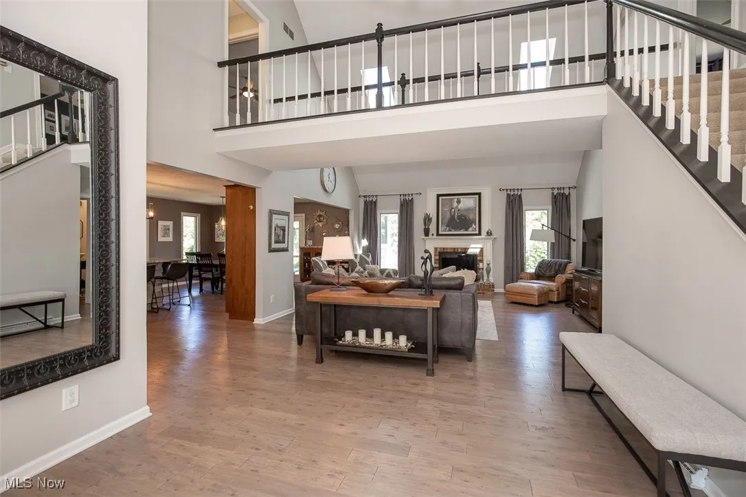 Open concept living room with vaulted ceiling and skylights