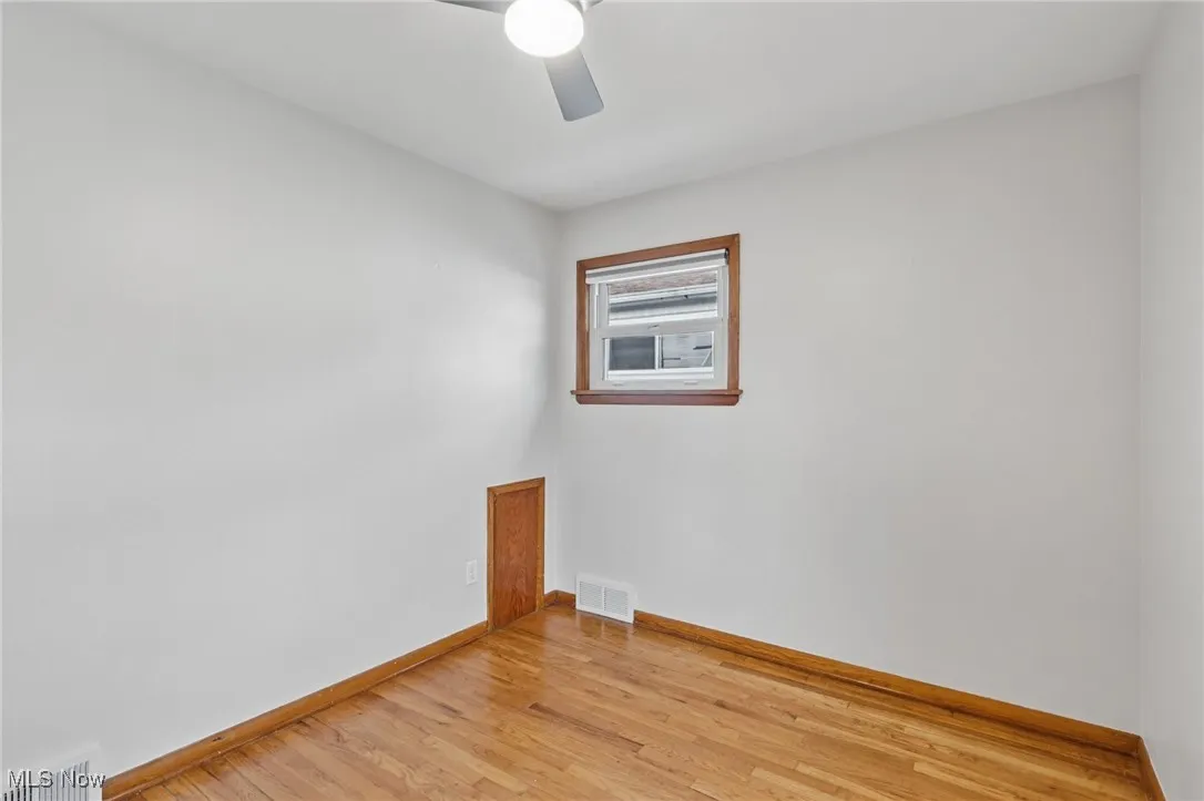 Spare room featuring light wood-style floors and ceiling fan