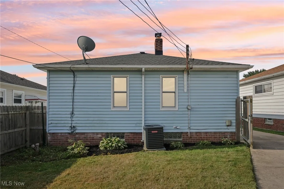 Back of property with a chimney and crawl space