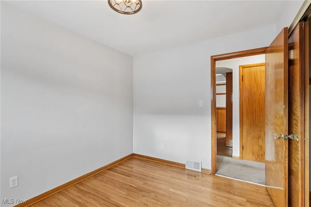 Empty room featuring light wood-type flooring and baseboards