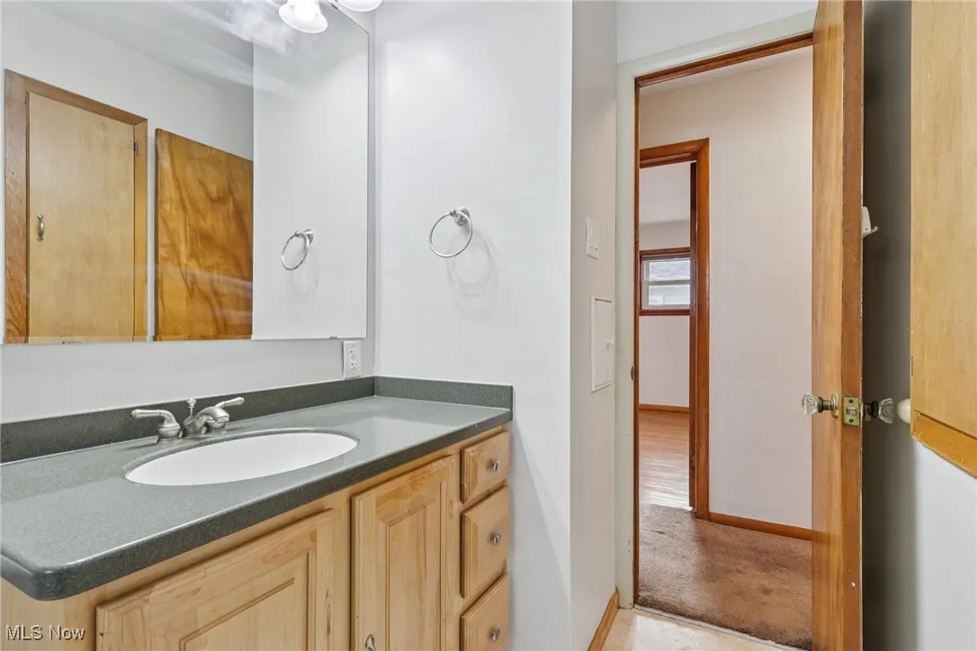 Bathroom with vanity and baseboards