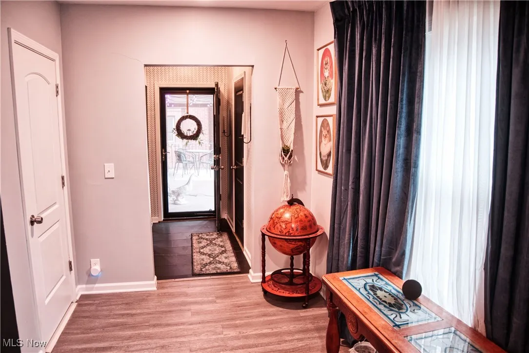 Foyer entrance featuring light LVT floors and baseboards