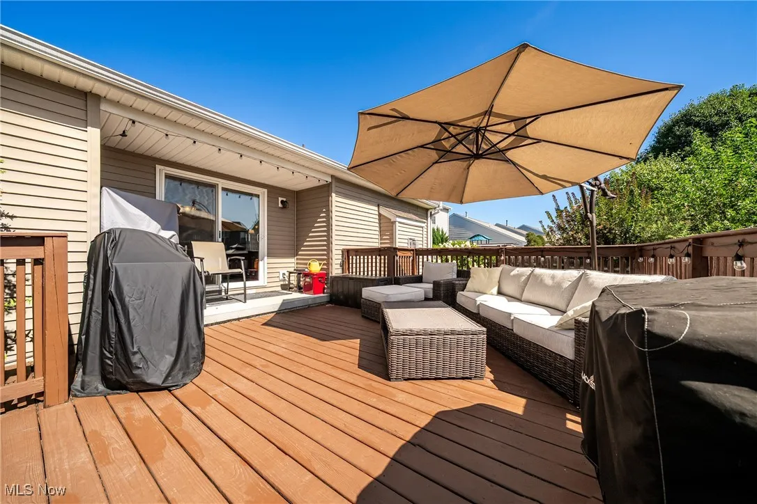 Deck with an outdoor hangout area and grilling area