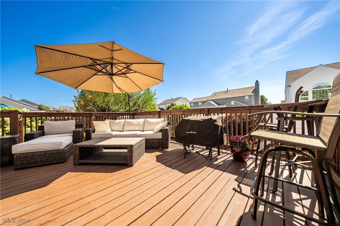 Deck with a grill and an outdoor hangout area