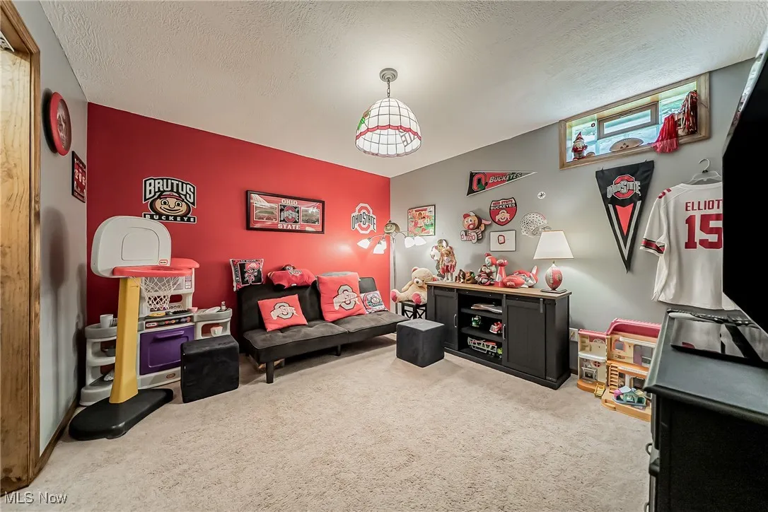 bedroom featuring light colored carpet and a textured ceiling