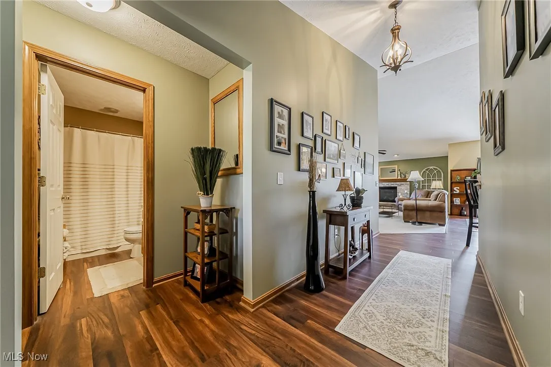Hallway featuring dark wood-style floors and a textured ceiling