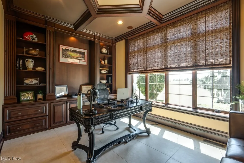 Office space featuring crown molding, built in shelves, light tile patterned flooring, and beam ceiling