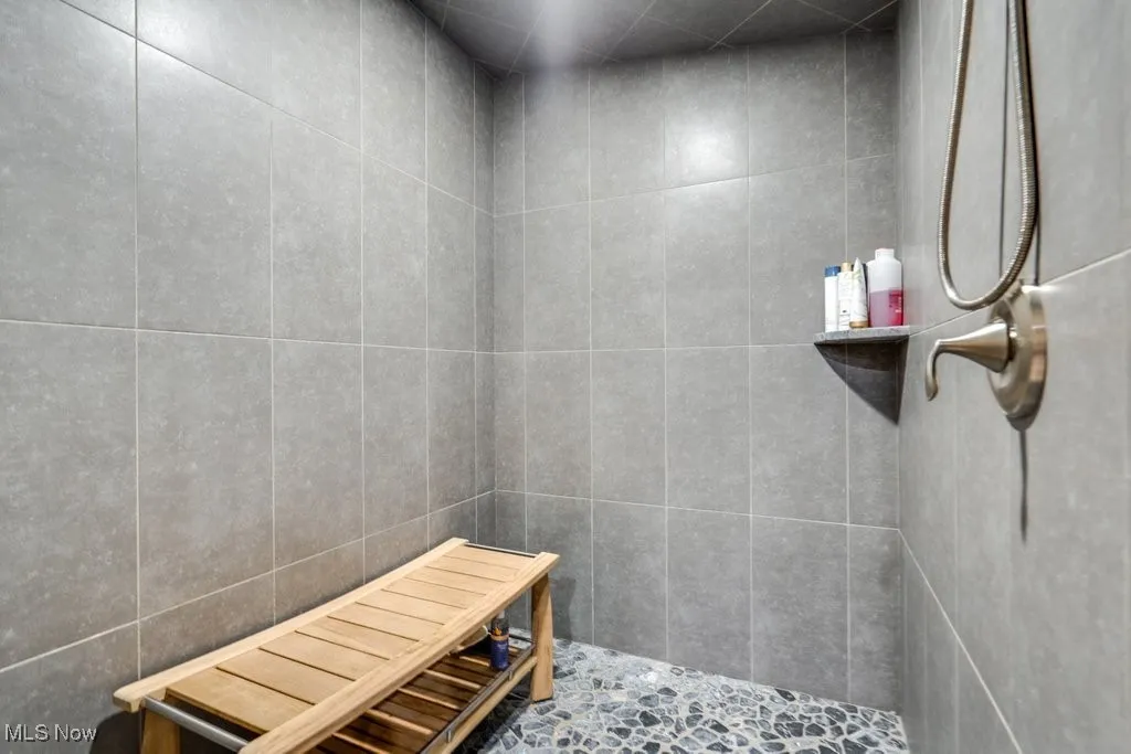Bathroom featuring tiled shower and a relaxing sauna