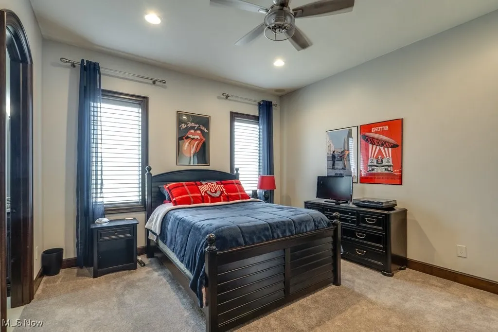 Bedroom featuring light colored carpet, a ceiling fan, and recessed lighting