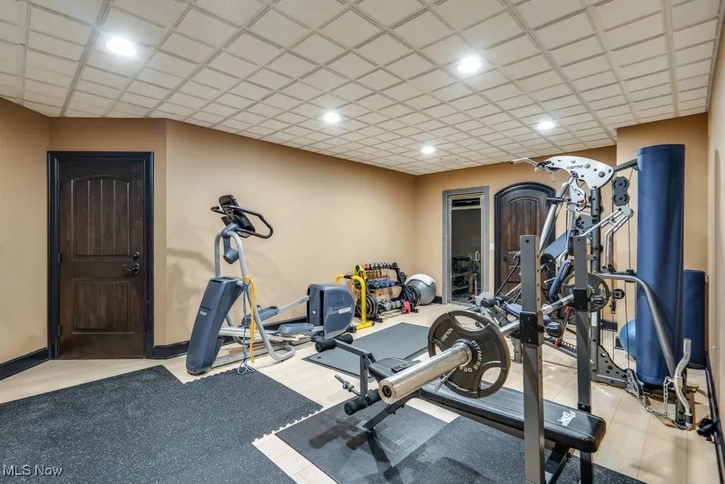 Workout room with baseboards and light wood finished floors