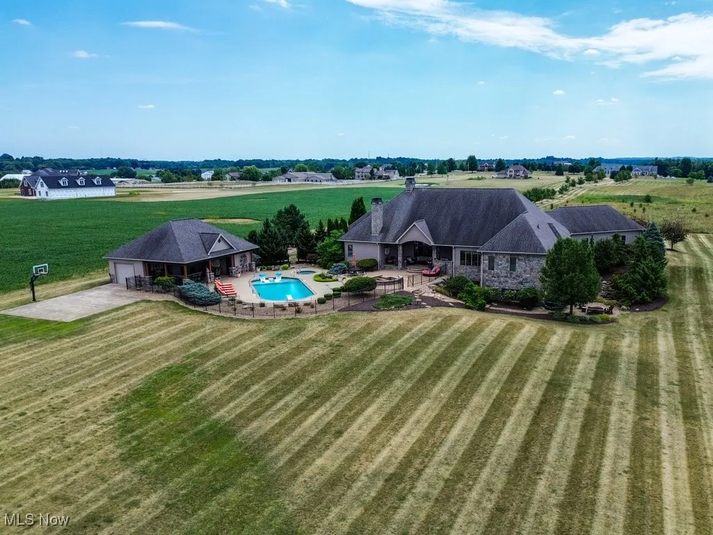 Aerial view of sparsely populated area featuring a pool