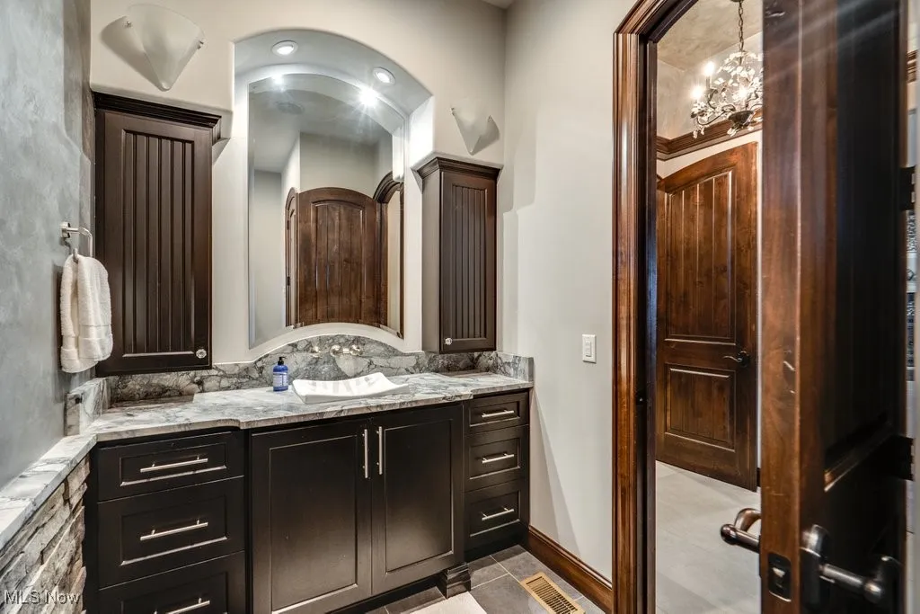 Full bathroom featuring vanity and light tile patterned floors