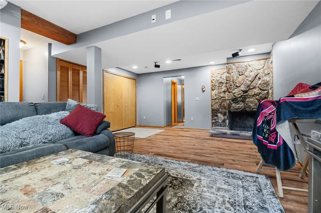 Living area featuring wood finished floors, a fireplace, and recessed lighting