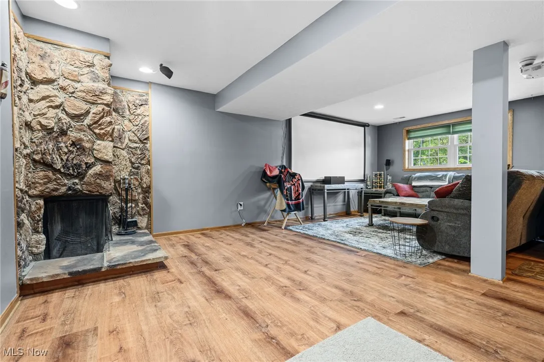 Living area featuring a fireplace, light wood-style floors, and recessed lighting