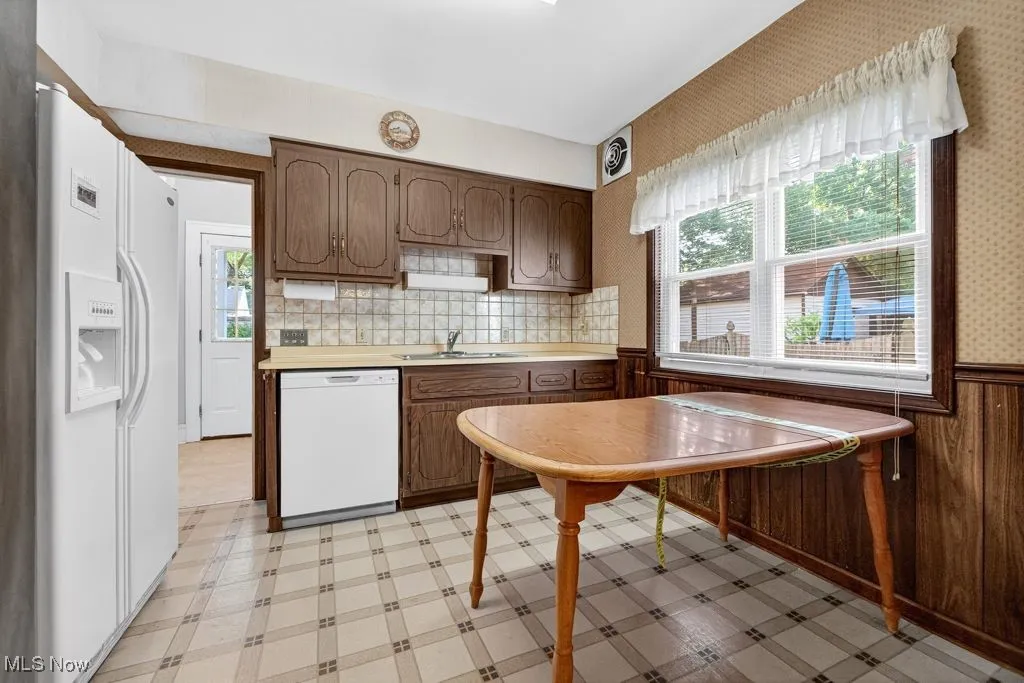 First Floor Kitchen with light floors, white appliances.