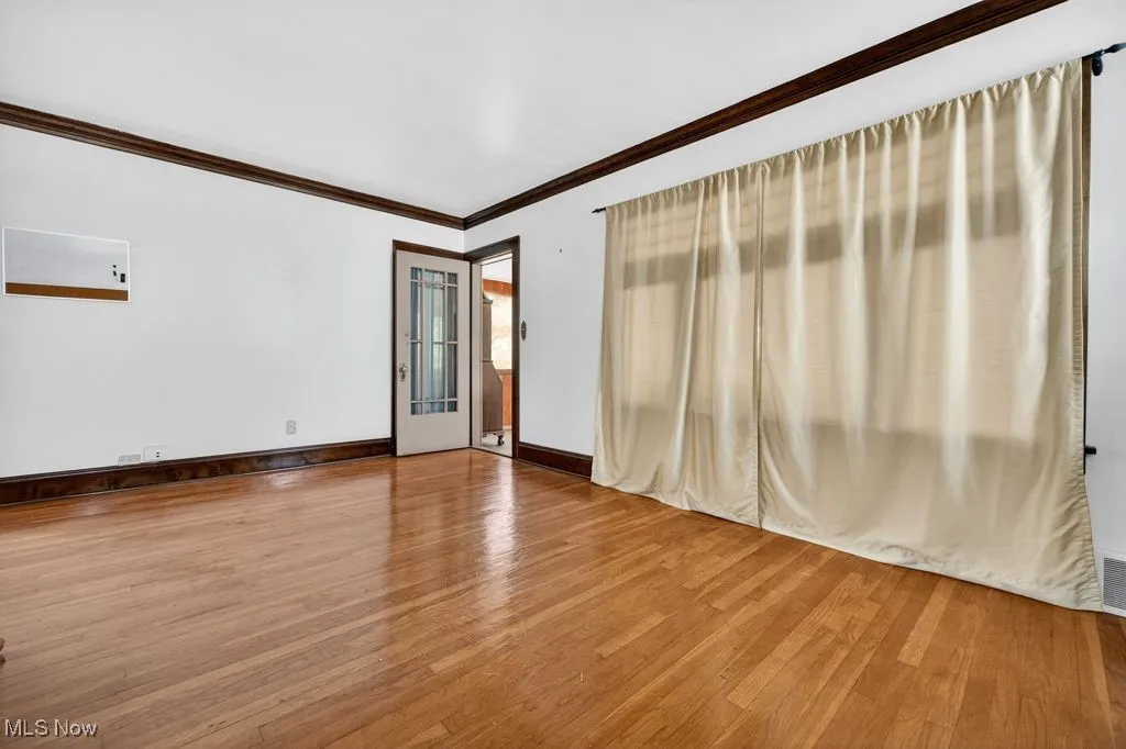 Second Floor living room with hard wood-style flooring, crown molding, and a fireplace