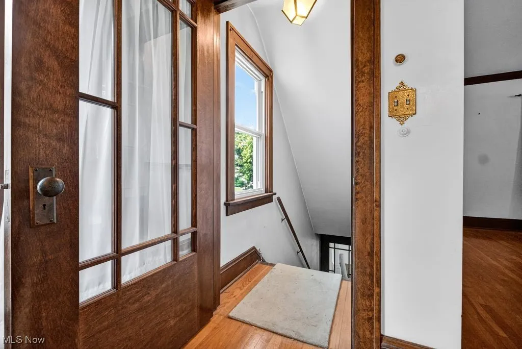 Second Floor Corridor featuring wood finished floors, an upstairs landing, and vaulted ceiling