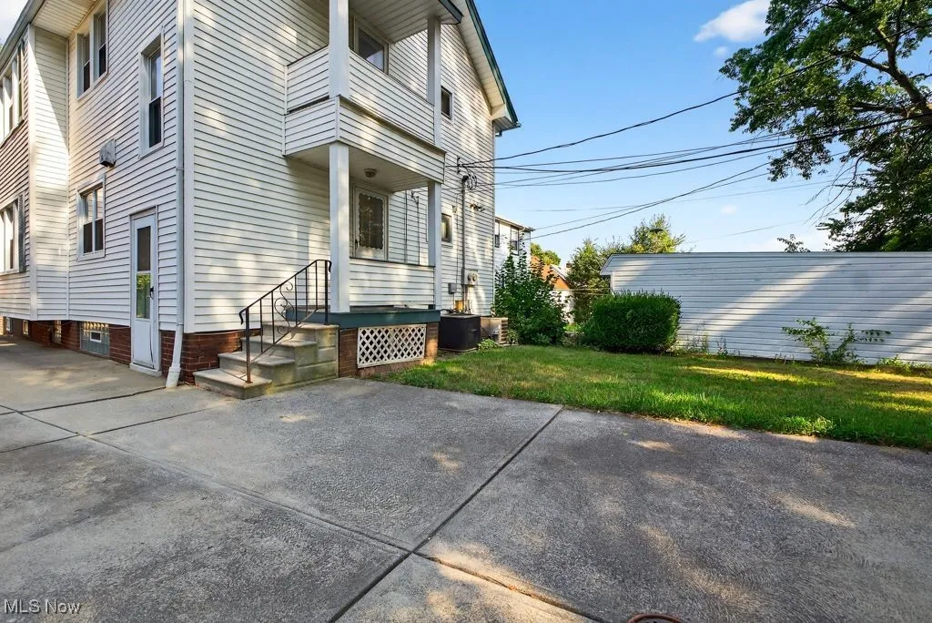 View of side of home with a lawn